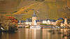 Aerial view of a Moselle town with a church and river under a cloudy sky.